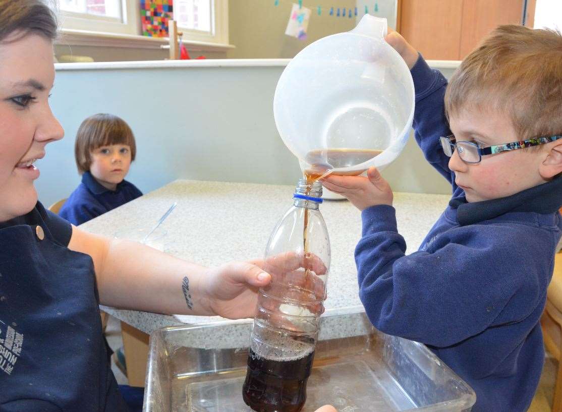 Children used baking powder and food colouring to carry out the science experiment