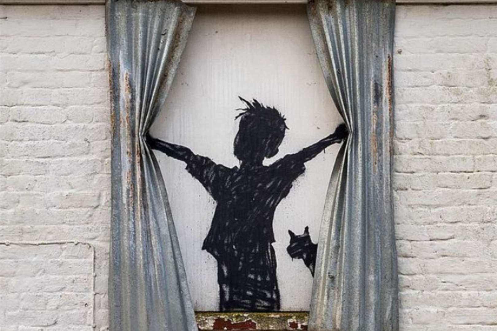 The Herne Bay Banksy shows a boy opening the curtains inside a house. Picture: Banksy/Instagram