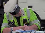 An officer writes up a ticket
