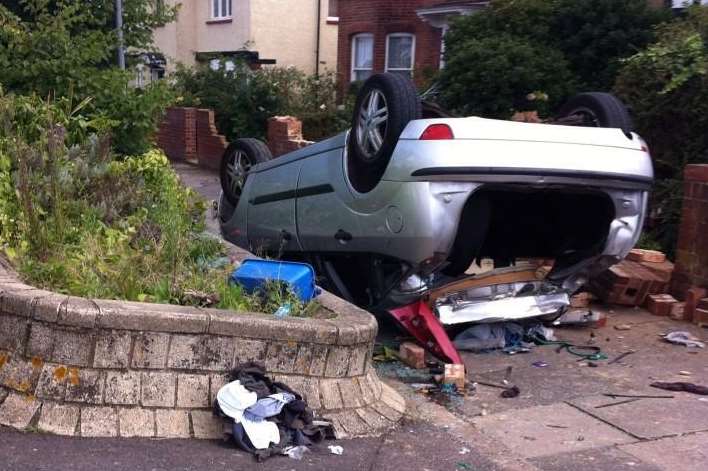 The car overturned in a front garden in Gravesend. Picture: @kelsbarham