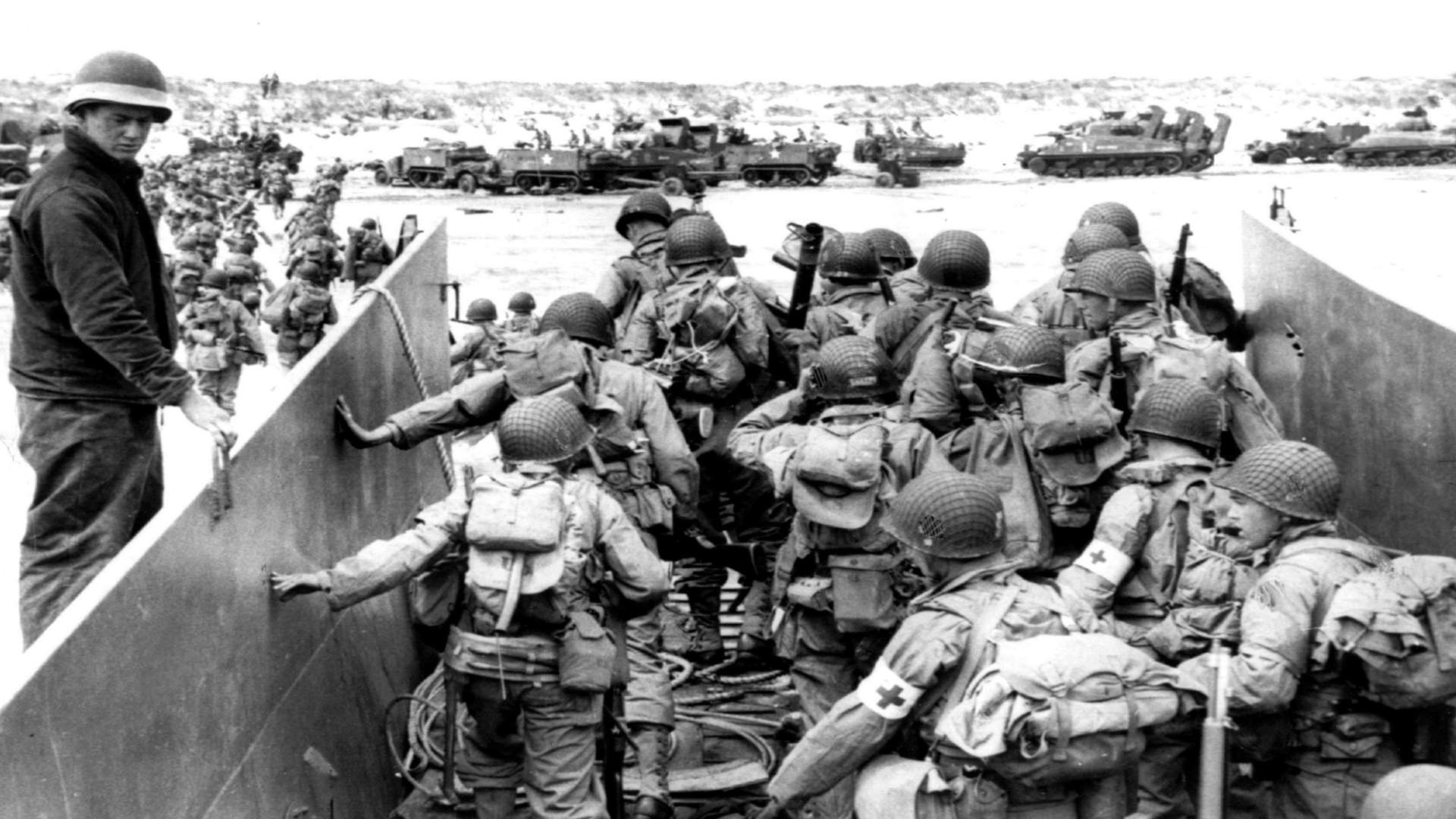 US Army soldiers disembark from a landing craft during the Normandy landings (D-Day)