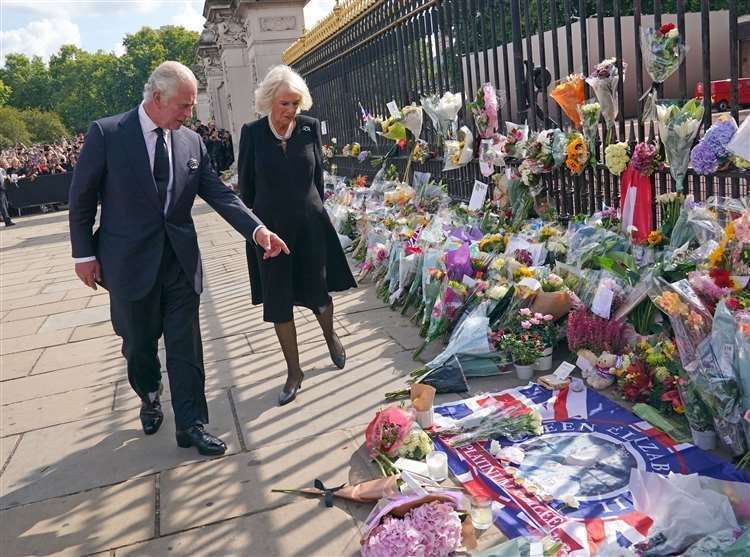 On Friday King Charles III and the Queen viewed tributes to the Queen left outside Buckingham Palace (Yui Mok/PA)