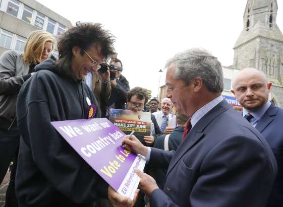 Ukip leader Nigel Farage signs campaign posters