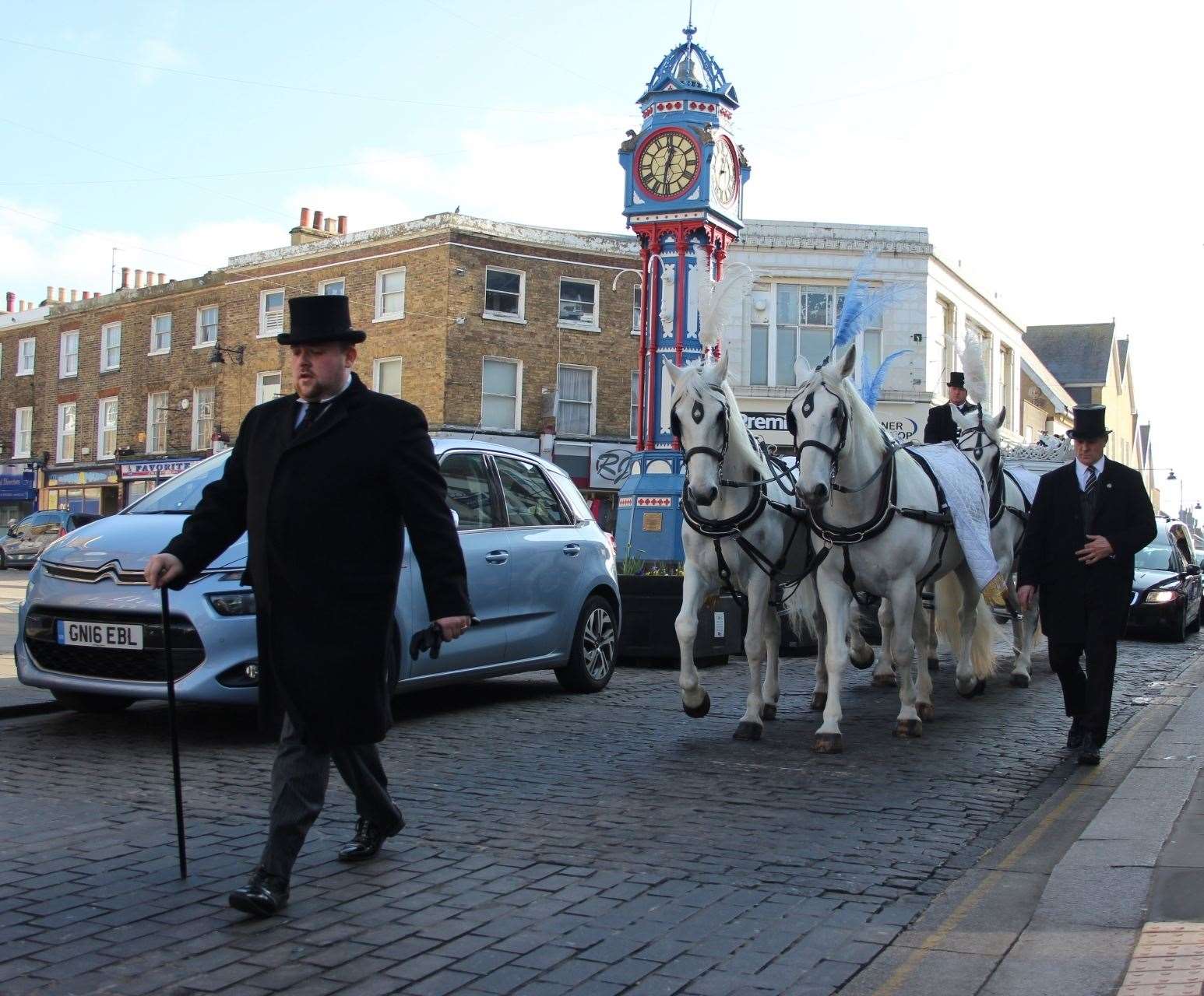 Bobby Palliser leading a hearse pulled by four white horses through Sheerness