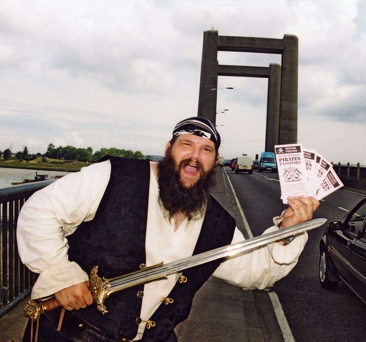 Captain Cutlass of the Sheppey Pirates giving out 'passports' for the World Walking The Plank championships at the Kingsferry Bridge