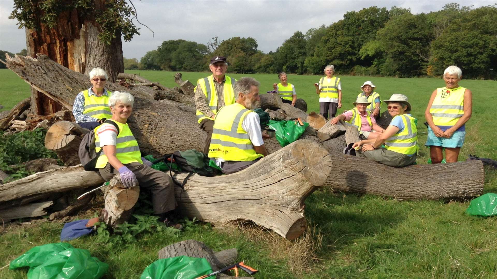 Members of the U3A group make the most of the ‘natural’ bench and take a breather during their three mile litter-pick.