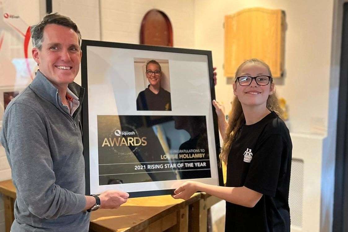 Mark Butterworth, Biddenden Squash Club chairman, presents Louise Hollamby with her England Squash Rising Star of the Year award for 2021
