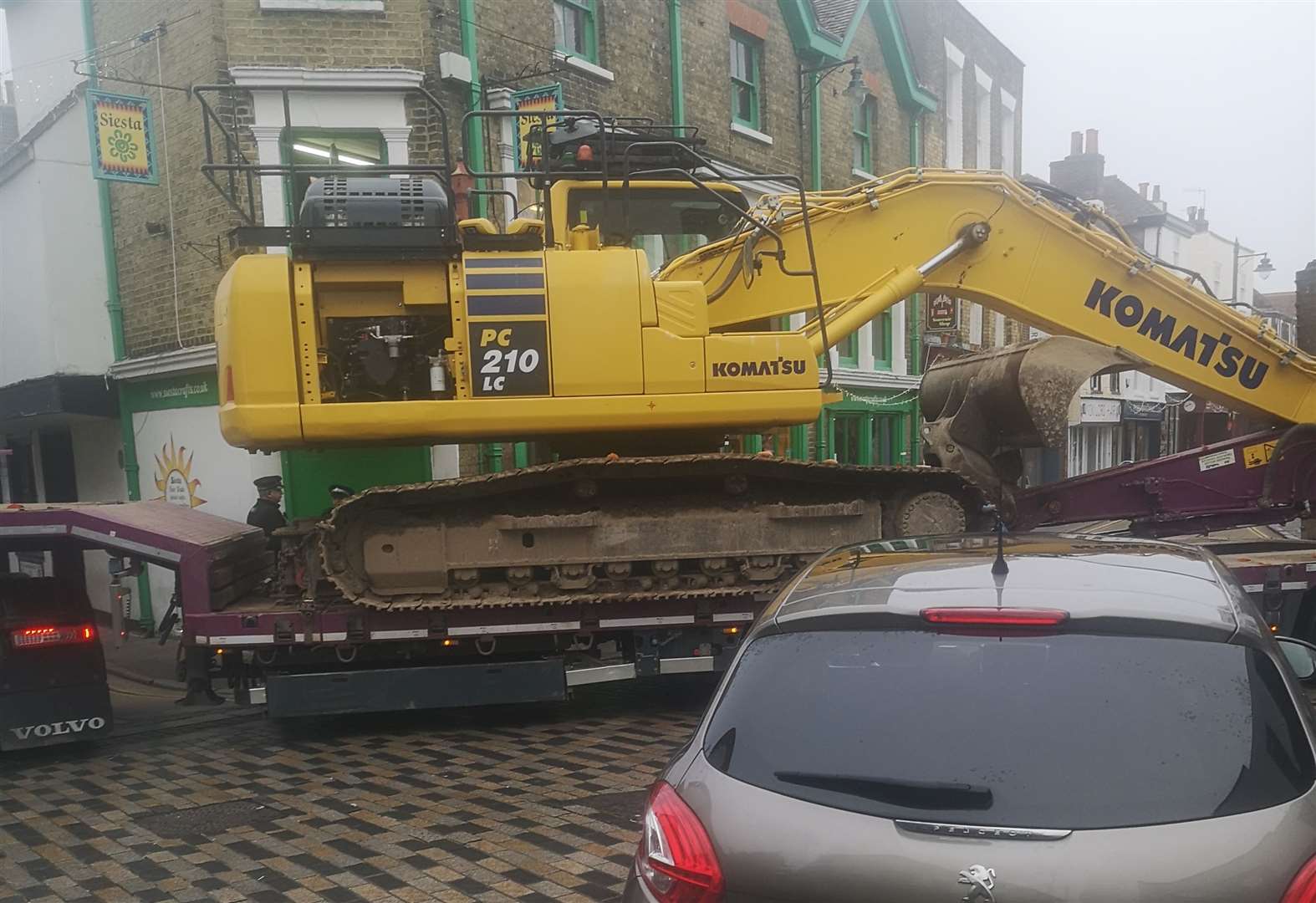 The lorry was carrying a digger when it got stuck in Canterbury