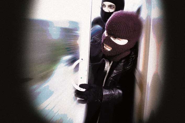 Burglars entering a home. Stock image
