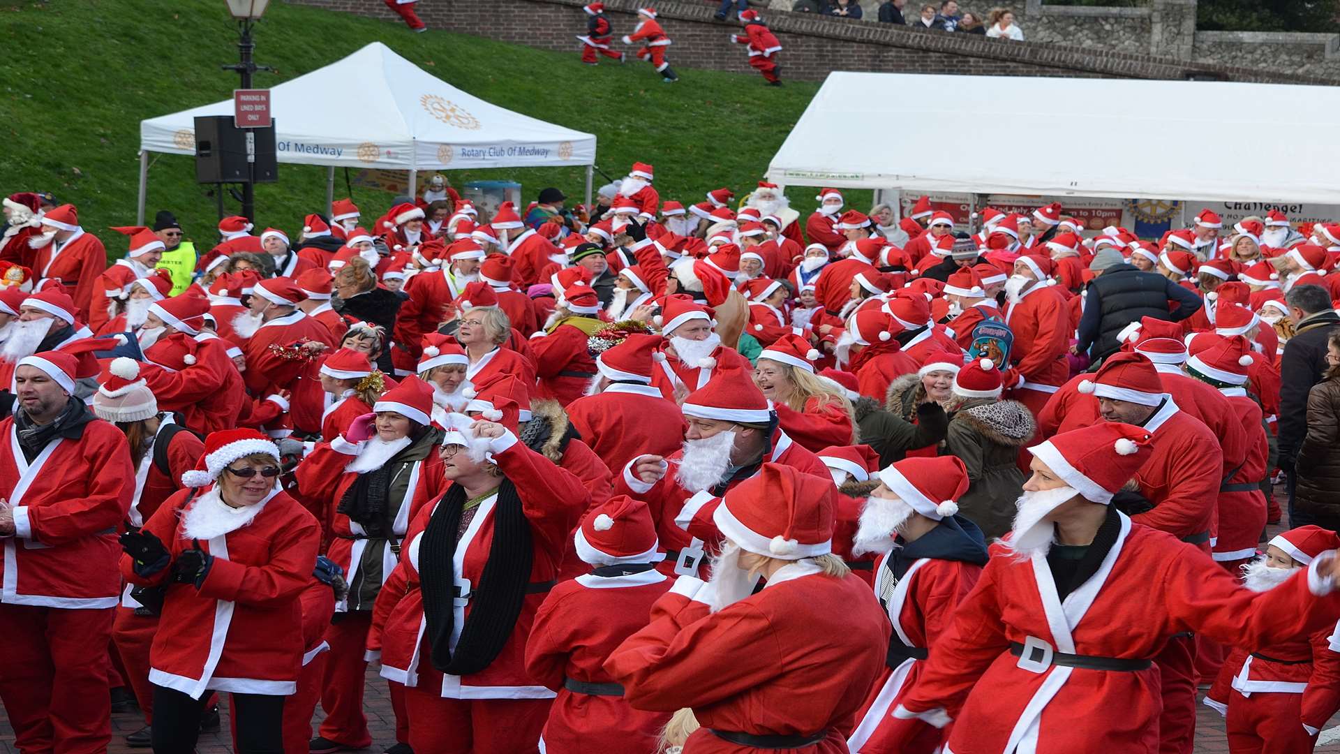 On your marks get set snow! The Santa fun runners gather at the start of the race outside Rochester Castle [credit: Jason Arthur]