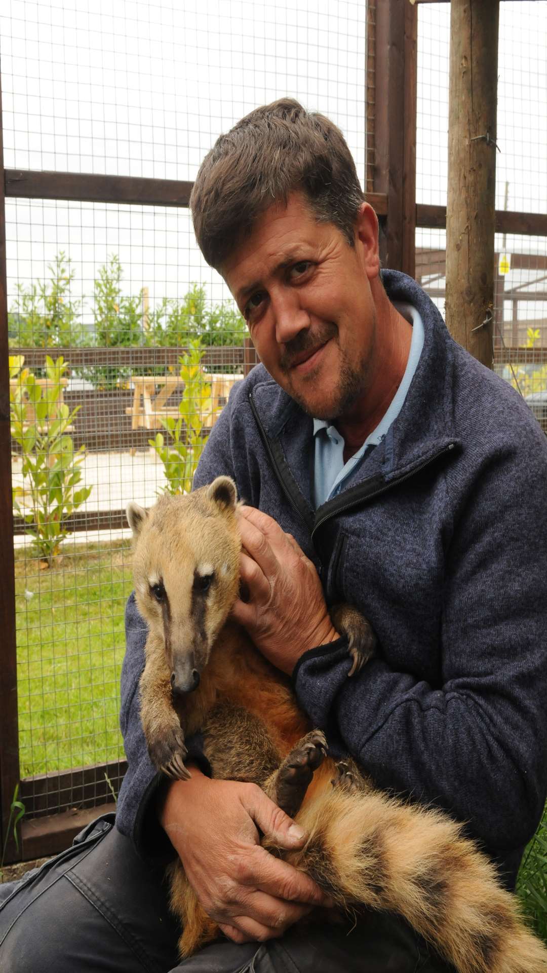Andy Cowell with Basil the coati - part of his menagerie