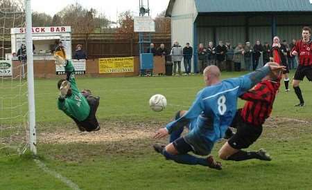 FLYING FEET: Goalmouth action from Saturday's match. Picture: STEVE CRISP