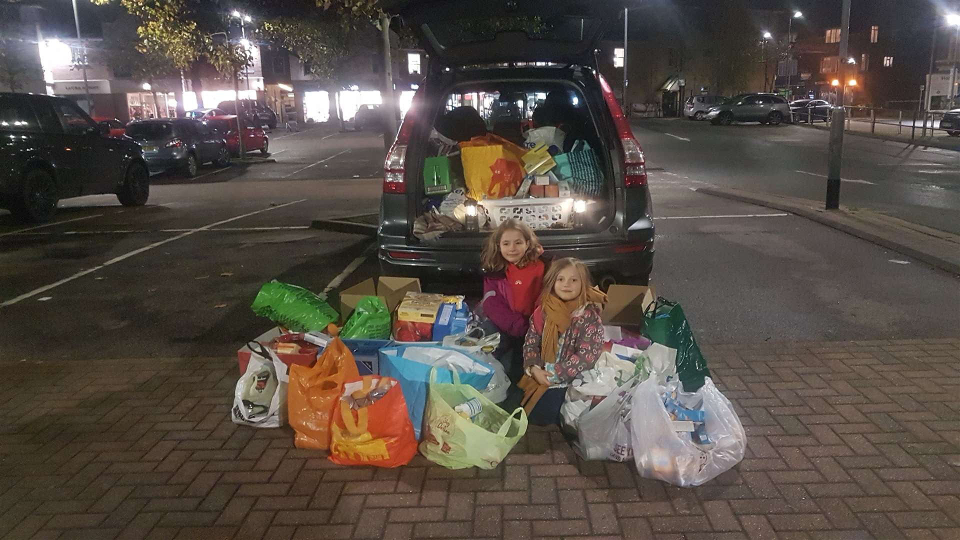Celia Rose, seven, and Rosie, nine, helping with the food collection in Bligh's car park in Sevenoaks