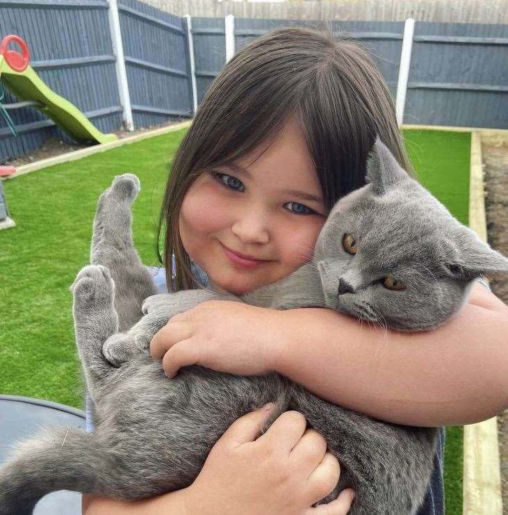 Ivy Saunders, six, with her cat Bear