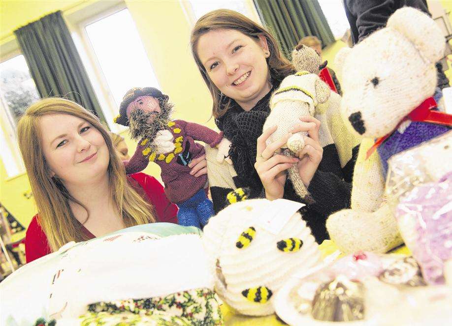 Jessica Butler and Samantha Butler with hand-knitted toys and crafts