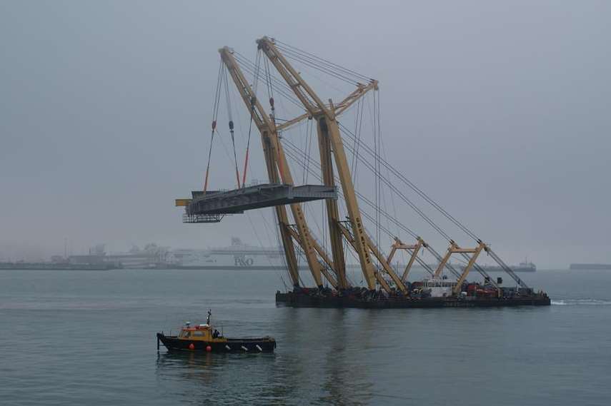 The section of berth being lifted and carried across the harbour to the Eastern Docks.