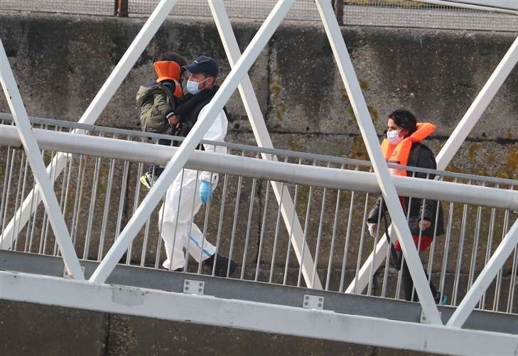 A group of people, including a child, are brought into Dover after attempting to cross the Channel (Gareth Fuller/PA)