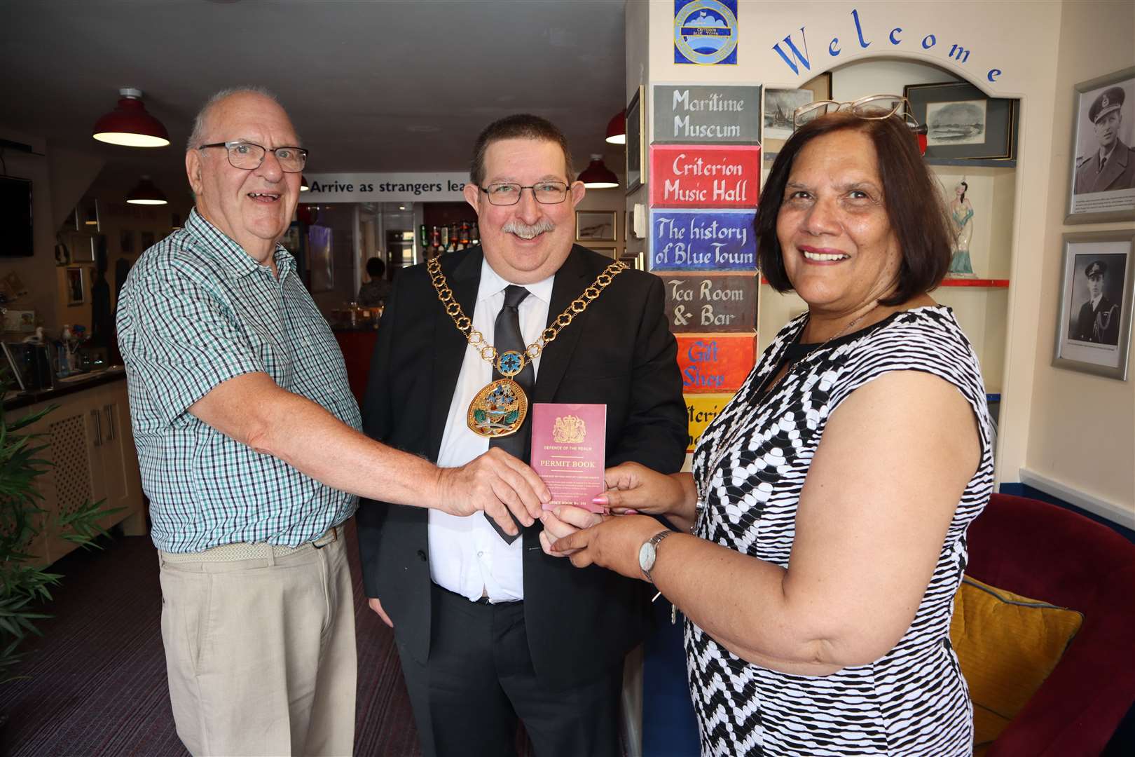 Swale mayor Simon Cook is presented with his own spoof Sheppey passport by Mike Brown and Jenny Hurkett of the Criterion Theatre