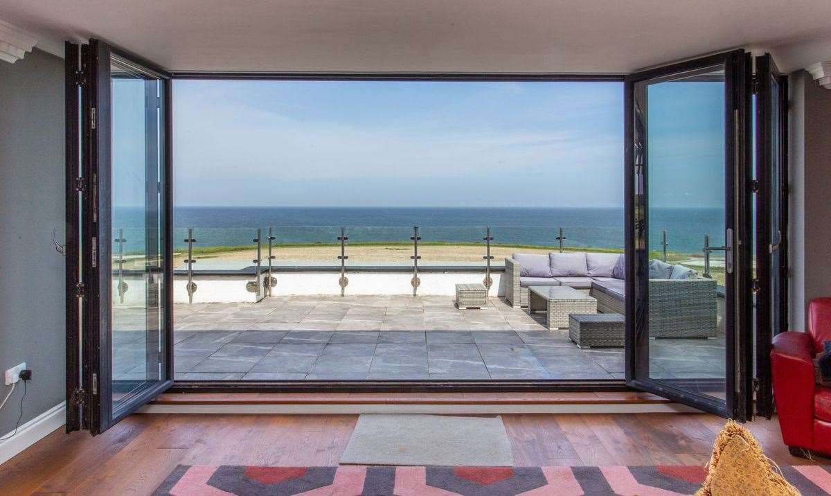 Take in panoramic views of the sea from the balcony. Picture: Miles and Barr