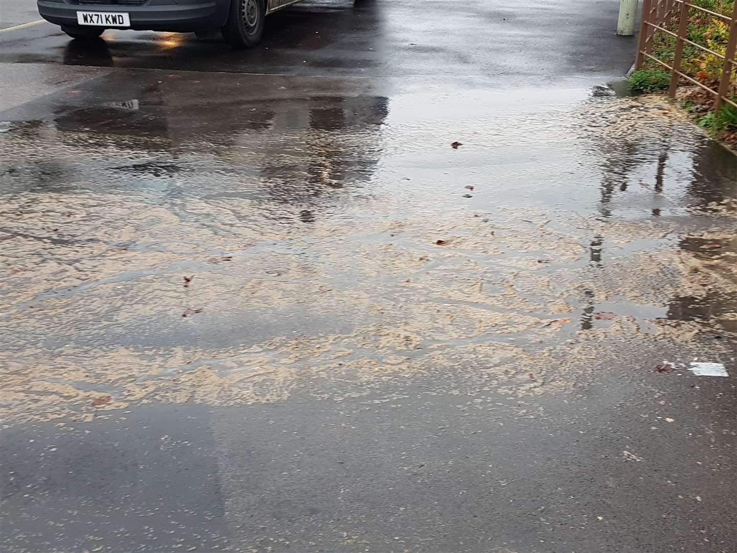The leak is covering part of the pavement