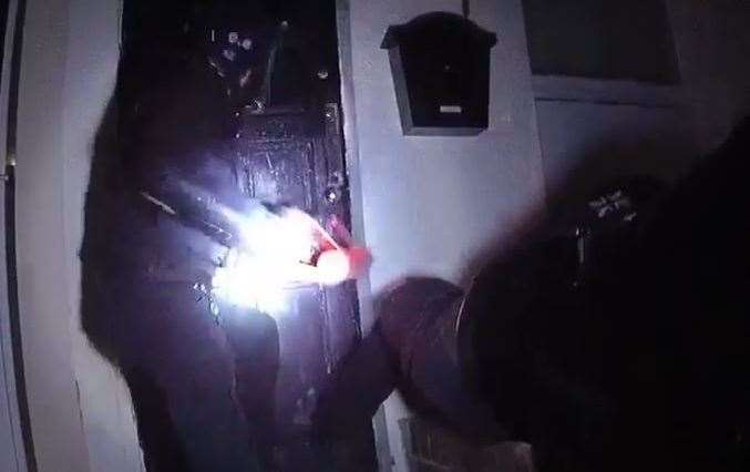 Busted. Officers break open a door in one of the raids. Picture: Kent Police