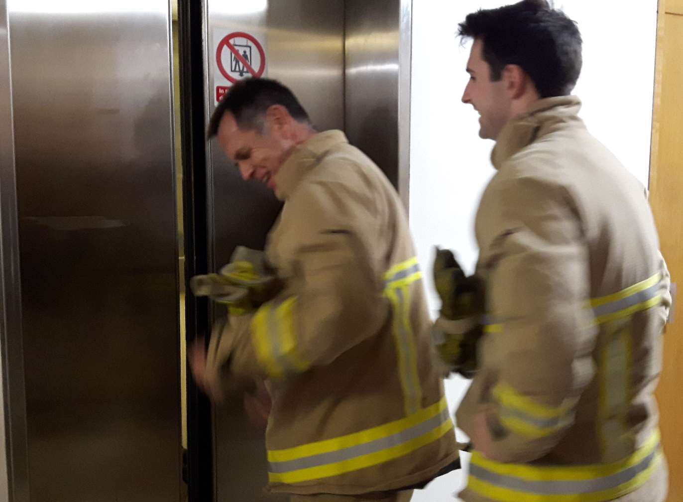 Firemen prepare to force open the doors