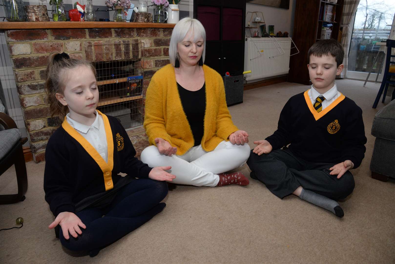 Claire MacGillivray of Staplehurst and her children Freya, seven and Aiden McBean, nine. Claire wants schools to introduce meditation in the mornings. Picture: Chris Davey. (6772505)