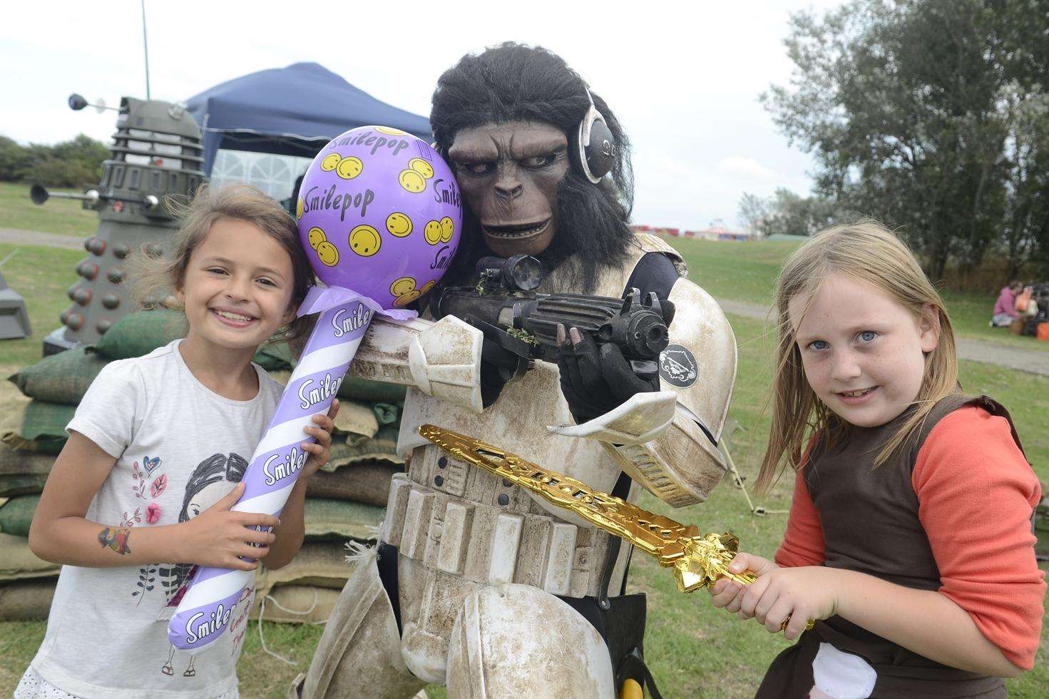 Rachel Fullbrook, eight, and Emily Walpole, seven, encounter 'Monkey Trooper' at the Sheppey Takeover sci-fi event