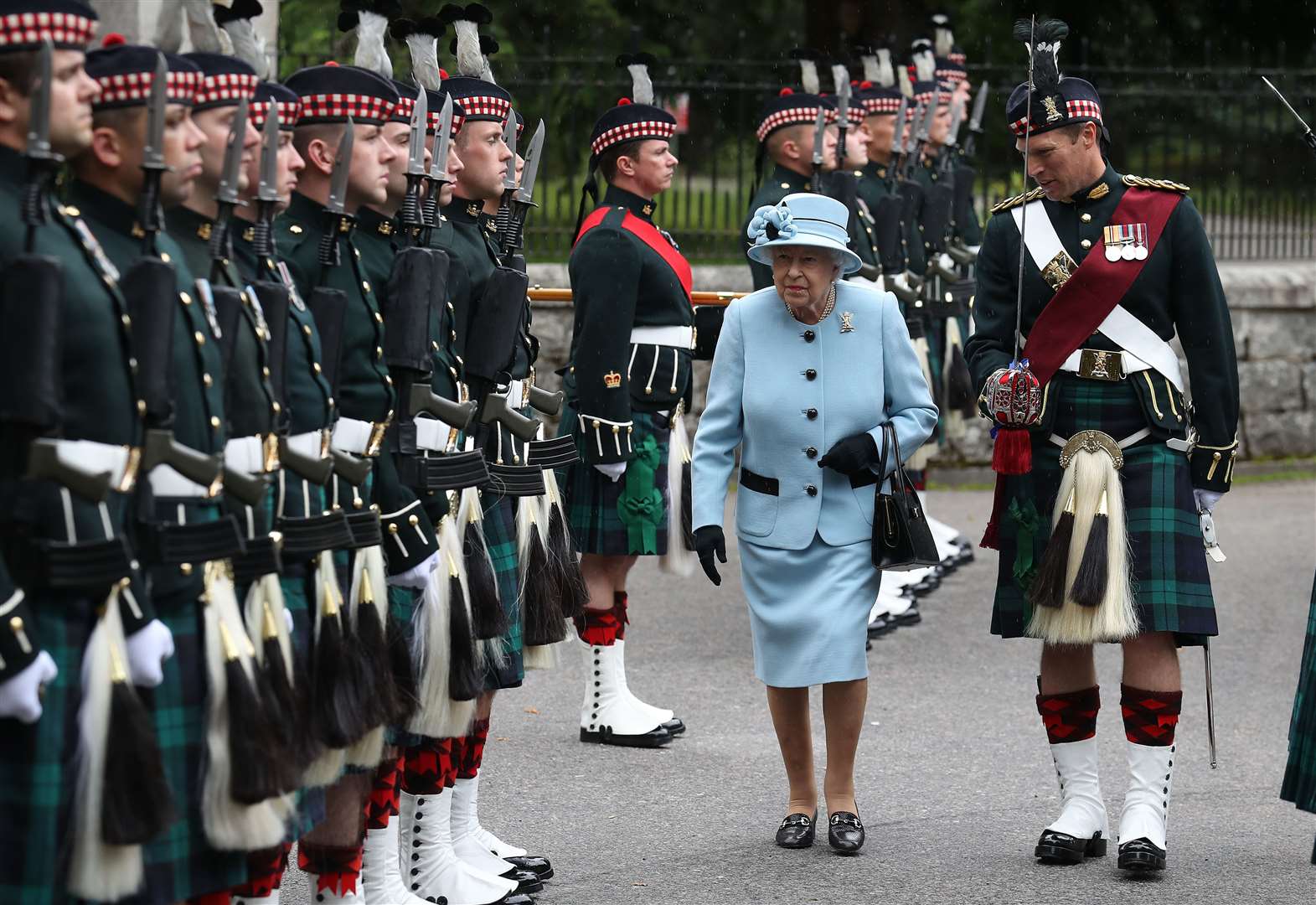 The Queen inspects the Balaklava Company, 5 Battalion The Royal Regiment of Scotland at the gates at Balmoral, as she took up summer residence in 2019 (Andrew Milligan/PA)