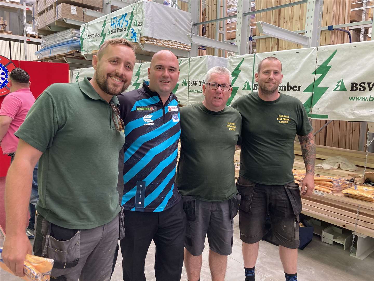 Darts player Rob Cross at the Selco Builders merchants Medway City Estate with workers from Dudrich (Holdings) Limited