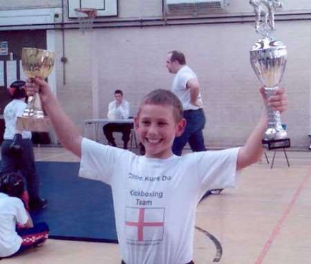 Nine-year-old Richard Bennett awarded the Gold Cup in kata and a trophy for his performance in the light contact continuous discipline