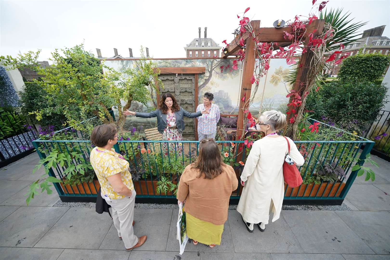 Designer Martha Krempel discusses her Arcadia balcony garden with visitors (Yui Mok/PA)