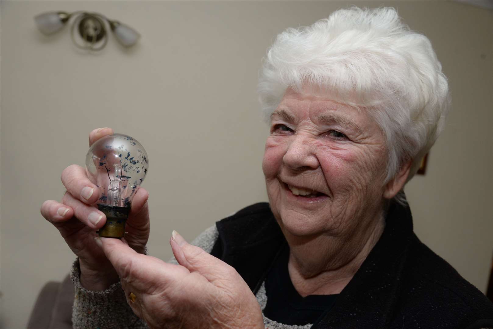 Valerie Beaney and the 75-year old lightbulb that still works. Picture: Chris Davey