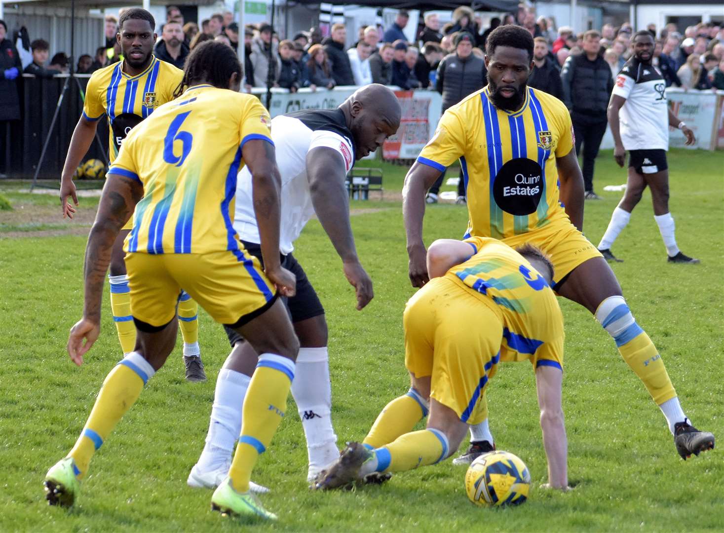 Faversham's Adebayo Akinfenwa is crowded out by Sittingbourne players as he suffers a 1-0 weekend defeat on his home debut. Picture: Randolph File