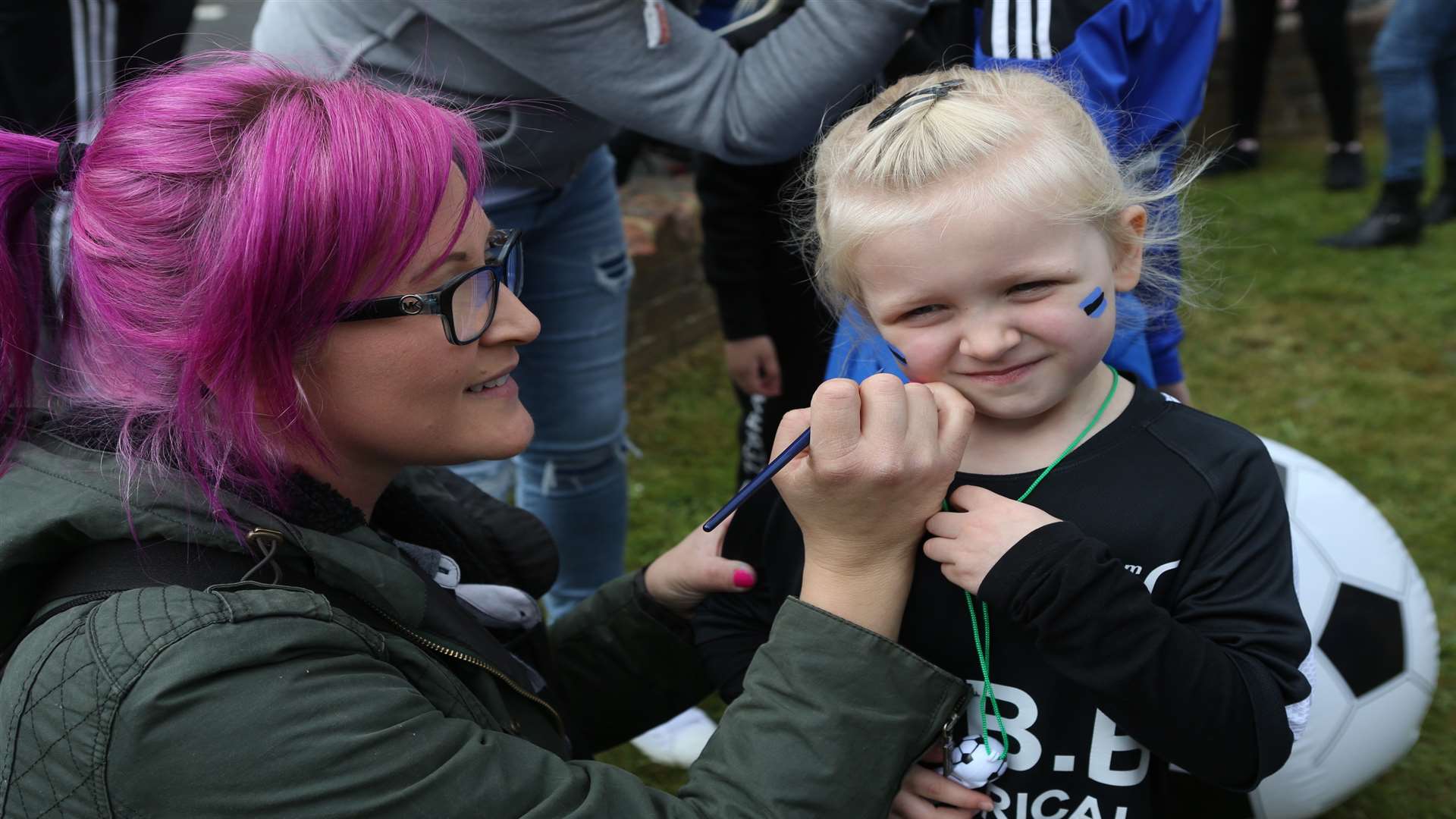 Becky Eyre paints her four-year-old daughter Matilda's face. Picture: John Westhrop
