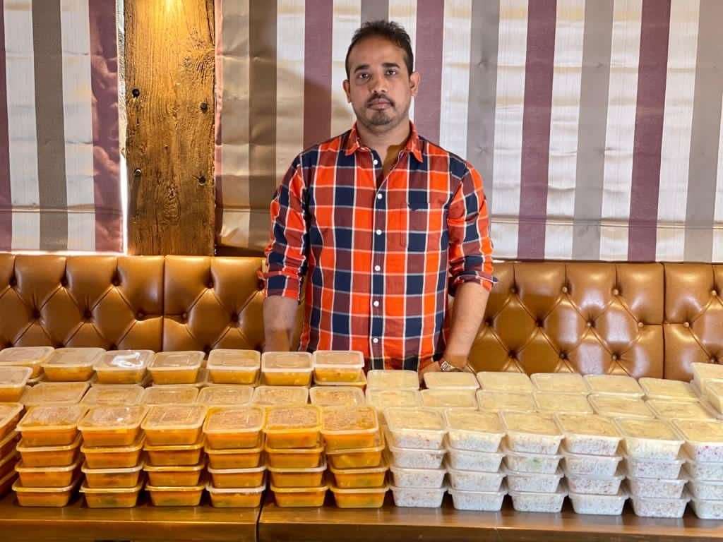 Saif Islam with the hundreds of donated meals. Picture: Saif Islam