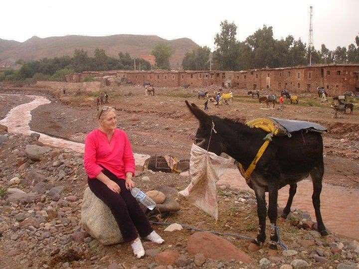 Denise in Asni, Morocco, on a break with a donkey