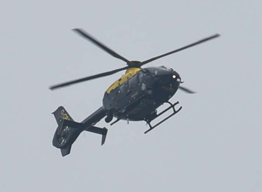 The police helicopter circled above. Stock picture