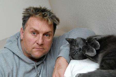 Ian Renfrew and his cat who was given the snip by the vets without consent