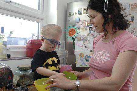 Stanley Turner, who has Crouzon syndrome helps mum Clare in the kitchen of their Western Esplanade, Herne Bay, home.