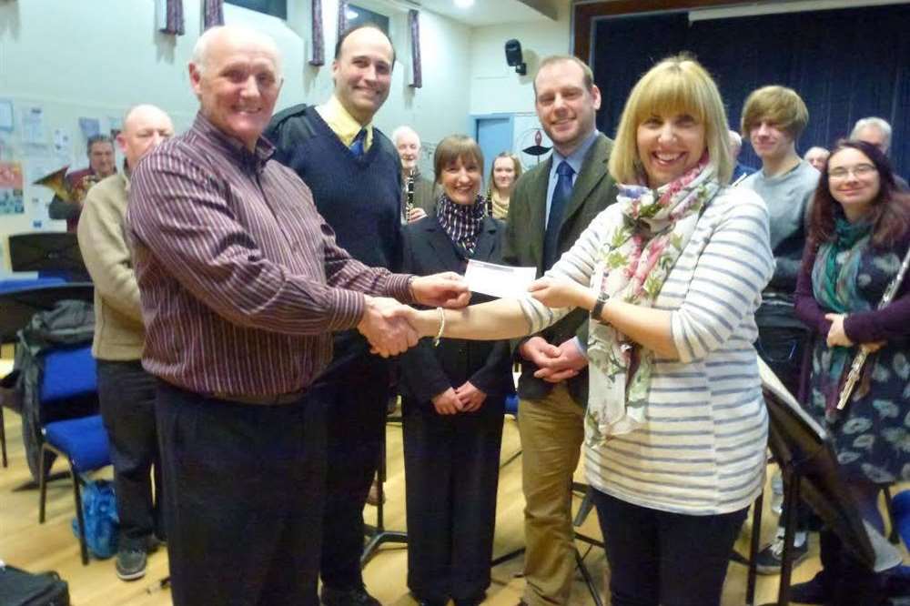 Graham Harvey, the director of the White Cliffs Symphonic Wind Band, presented a cheque for £1,500 to Home-Start.