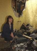 Maggie Rogers surveys the damage caused by fire at her home