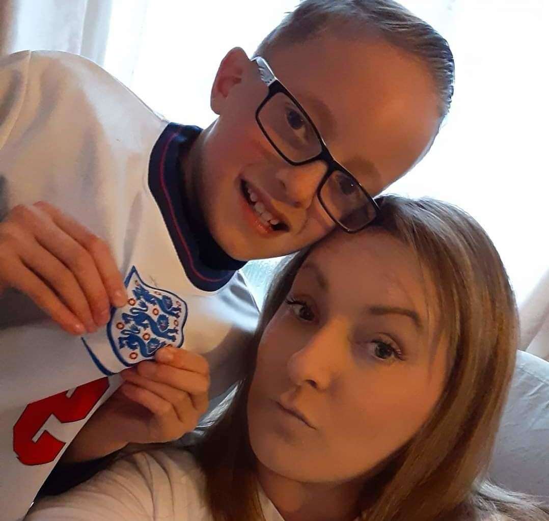 Kian Holt and mum Vicky, who says he 'eats, sleeps, and breathes' football. Picture: Vicky Holt
