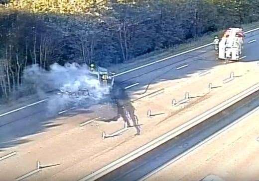 Firefighters at work extinguishing the van fire on the M25. Picture: National Highways South East