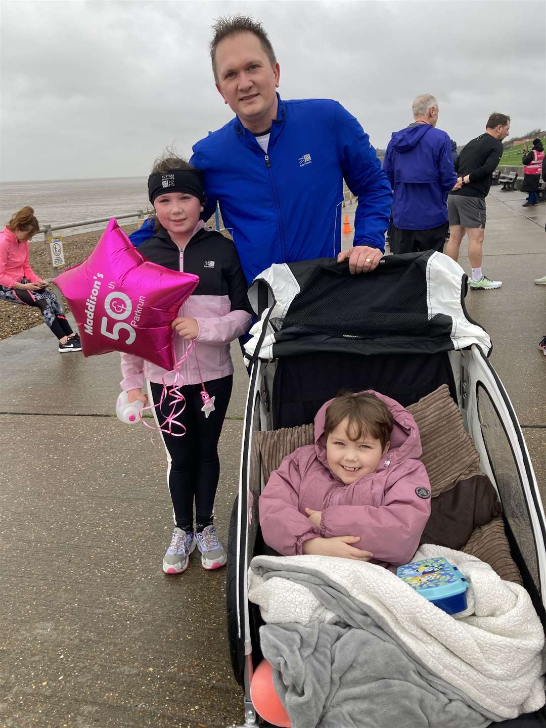 Maddison Townsend-Brazier, 10, was the youngest runner when Sheppey's 5k parkrun at The Leas at Minster celebrated its 100th anniversary on Saturday. She is pictured with her dad Tim and her sister Mollie