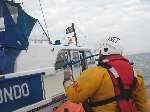 Helmsman John Croft brings the Whitstable Lifeboat alongside the motor cruiser
