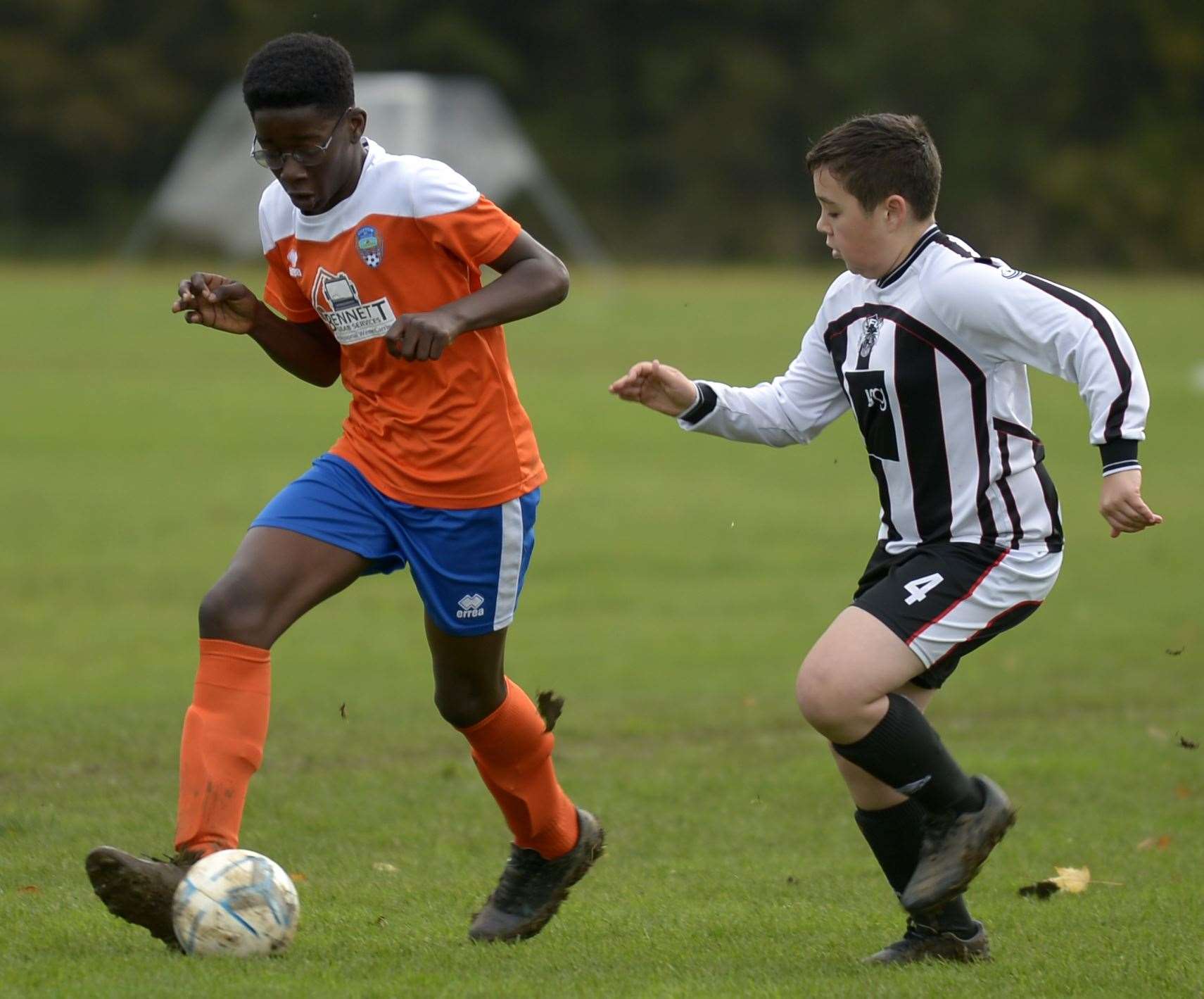 Cuxton 1991 Dynamos under-13s (orange) on the ball against Milton & Fulston United Zebras under-13s. Picture: Barry Goodwin (42936769)