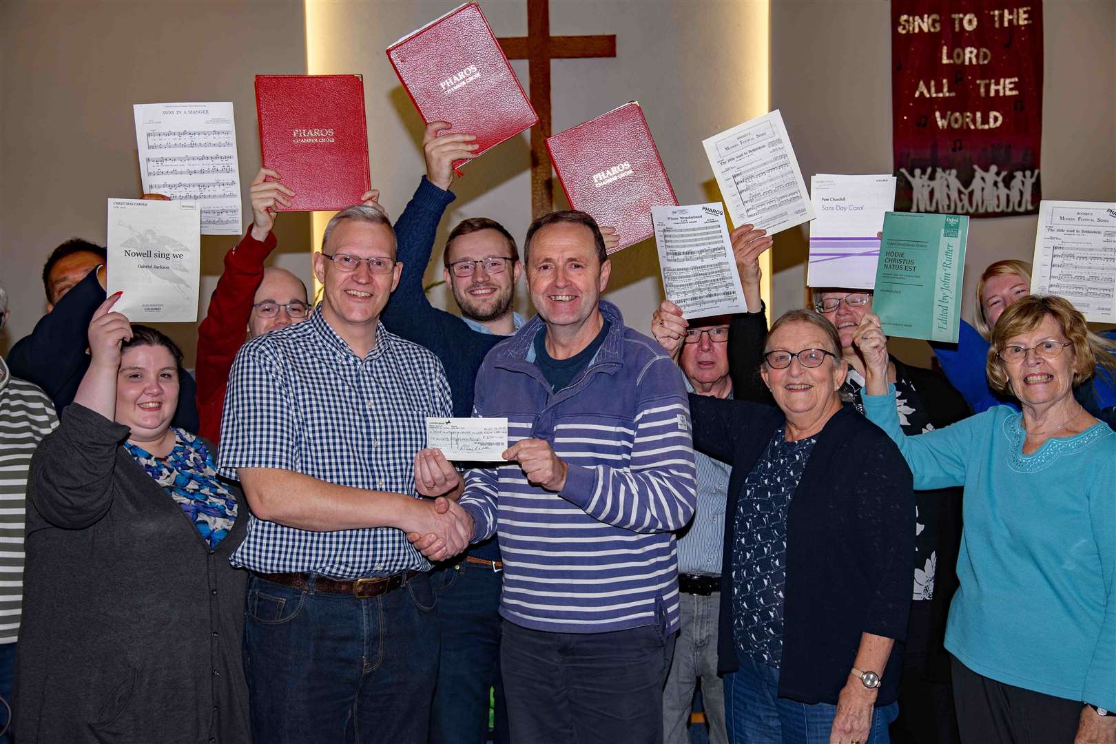 Pharos Chamber Choir founder/director Stephen Yarrow (left) presents a cheque for £650 to Noel Beamish of the Dover Winter Night Shelter. Photo: Donald Beck