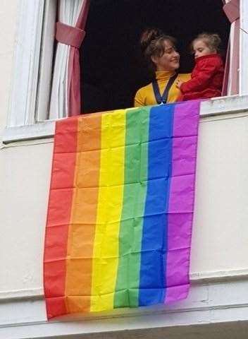Cllr Slade and her daughter with the rainbow flag being flown from the window of the town hall