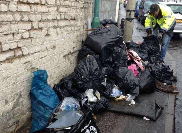 Inspector from Medway Council with some of the rubbish that was put out by the takeaway